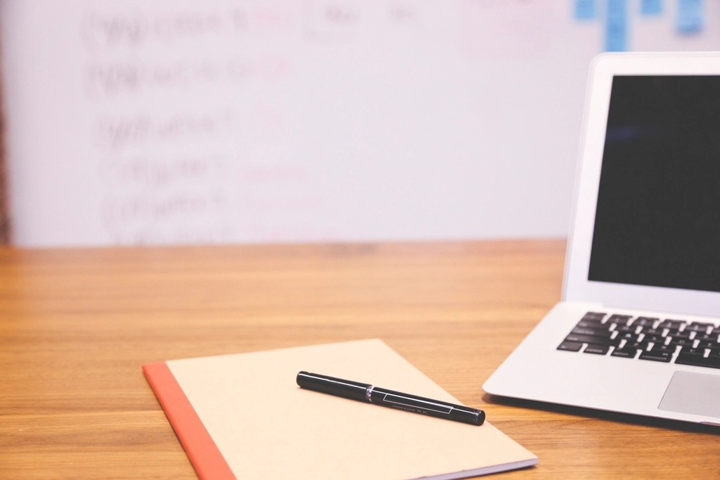 A desk with notebook — guides and workbooks in progress